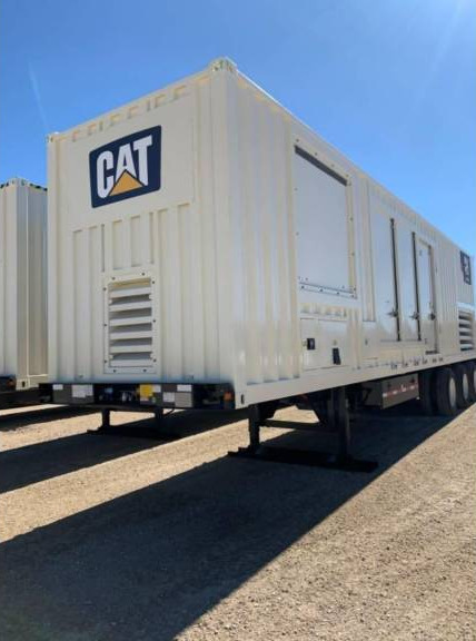 CAT mobile generator unit under a clear blue sky.